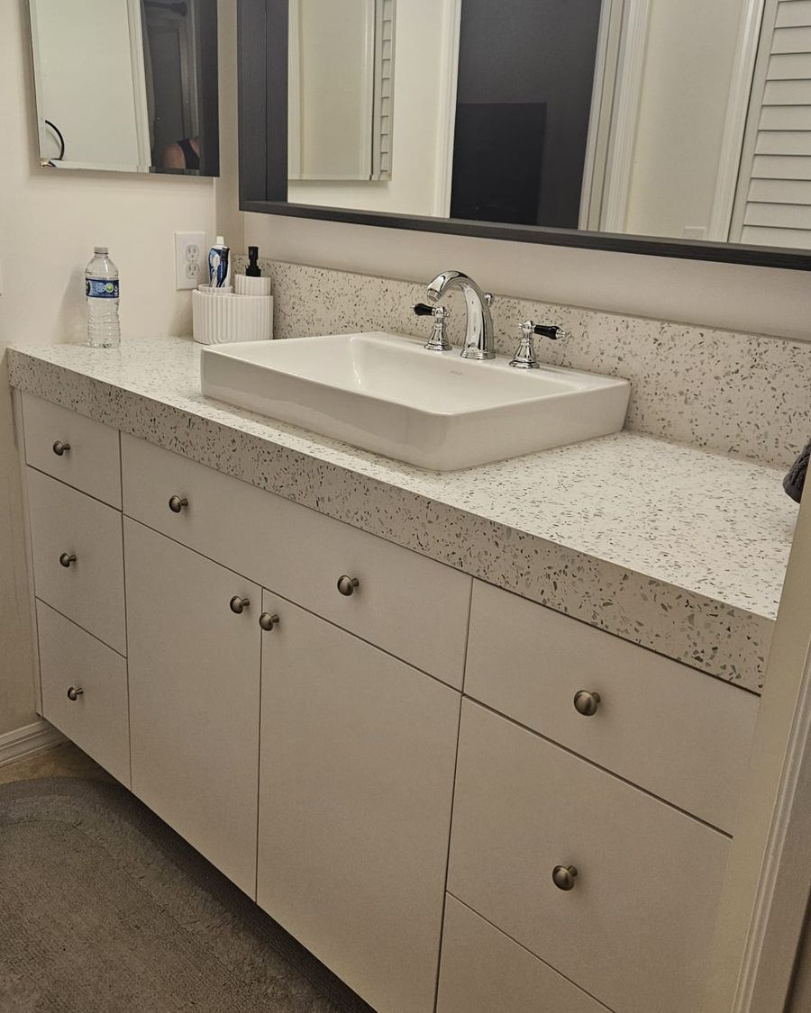 Bath vanity with a vessel sink and framed mirror